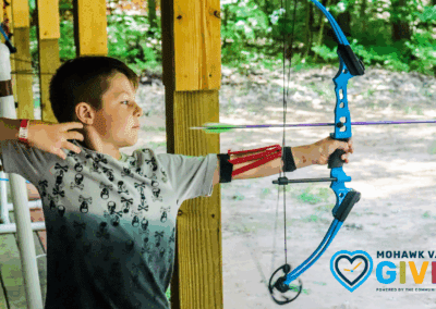 Scouts At camp Kingsley shooting archery