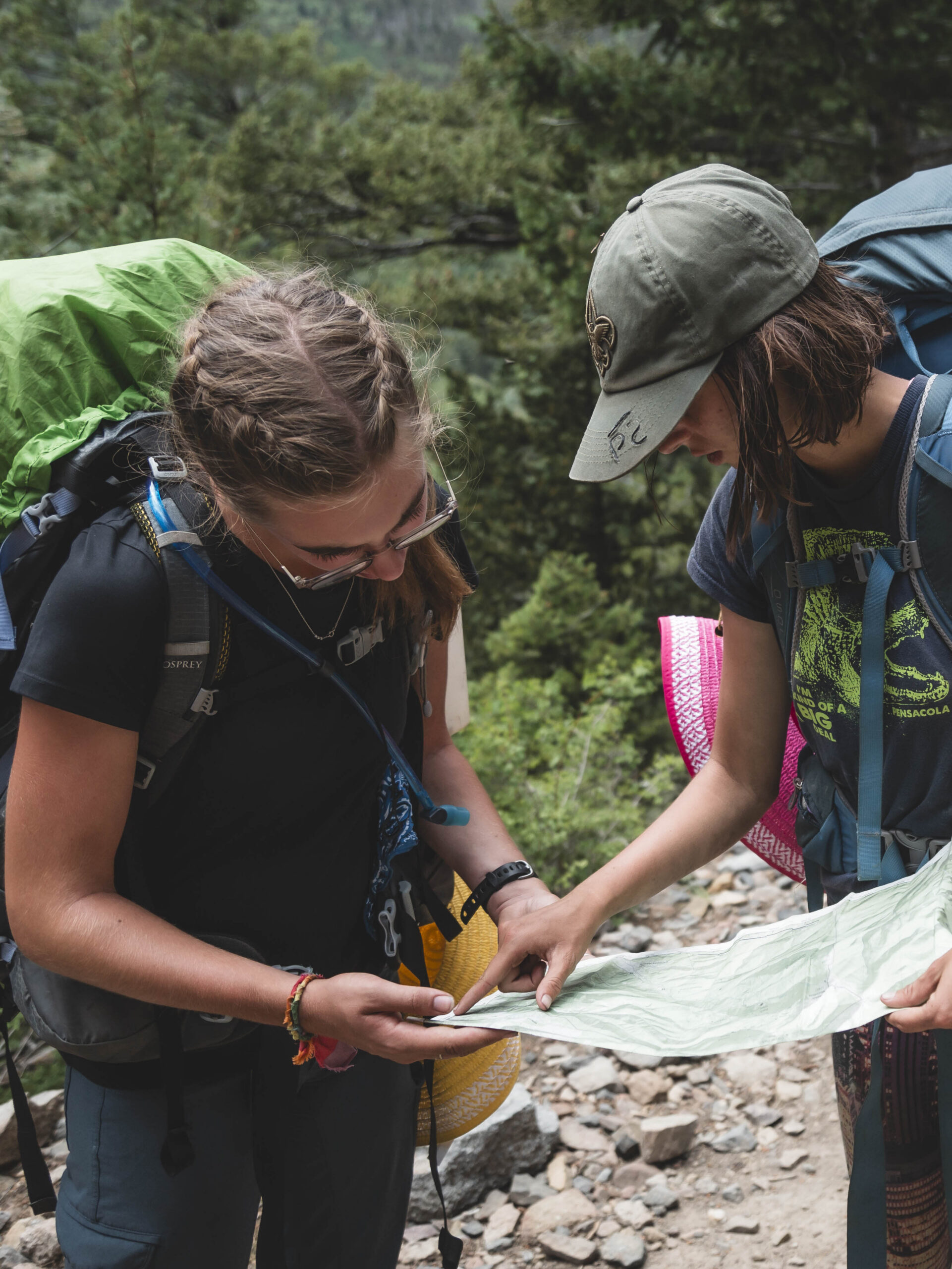 Scouts checking a map hiking on a trail 